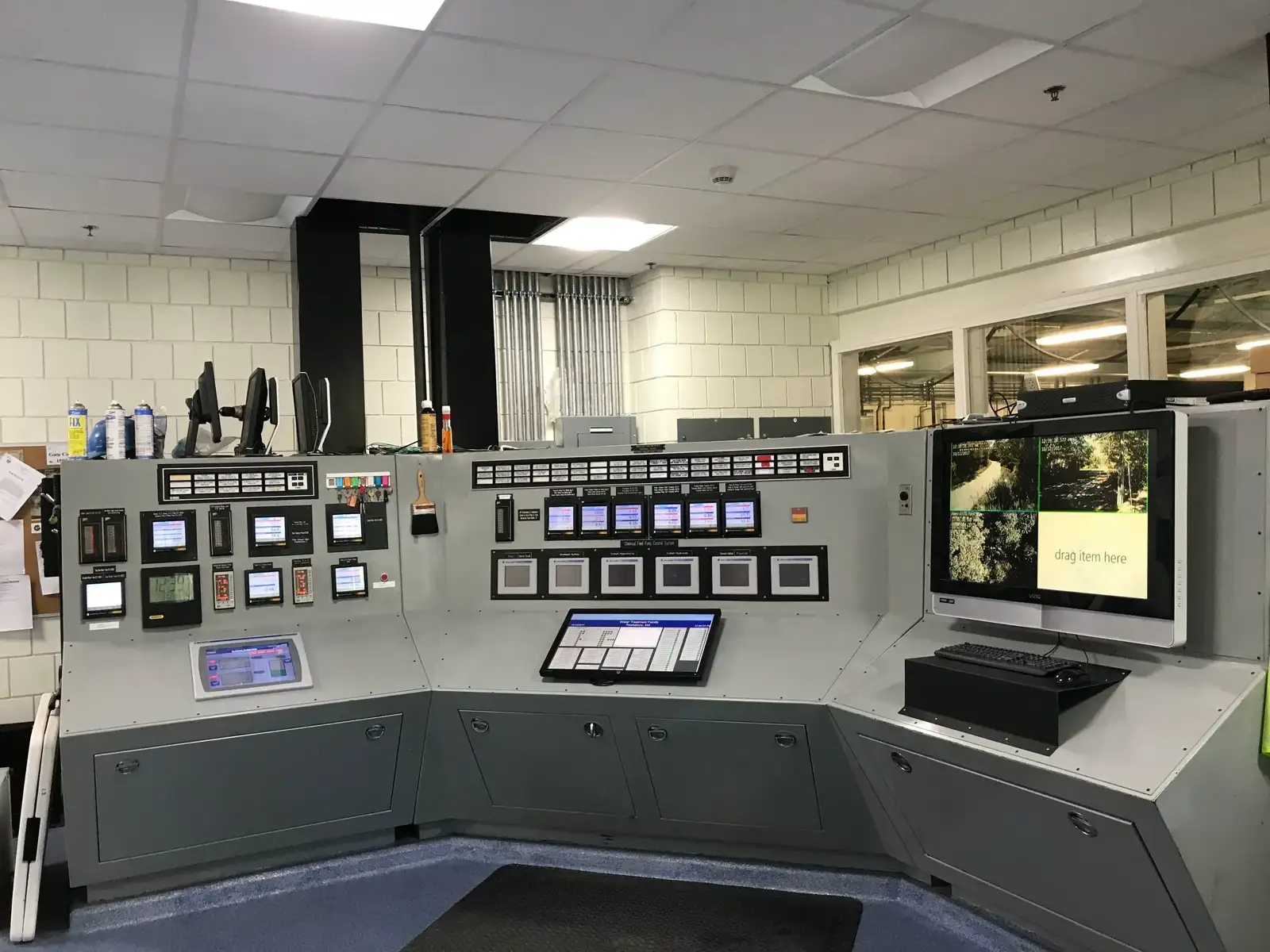 Control room console with monitoring displays and SCADA screens